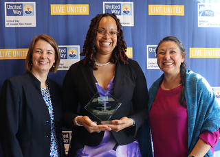 Group of people pictured with one person holding an award at the annual Live United Celebration.