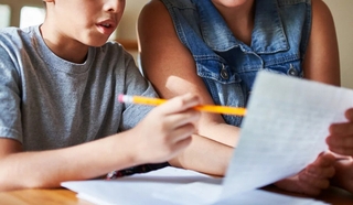 Child and adult looking at a document