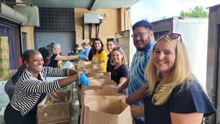 Yale employees helping the United Way of Greater New Haven pack and distribute over 1,200 grocery bags for local families in need.